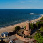 Drone view in the sunny day of lighthouse and harbor in Kolobrzeg, Poland.